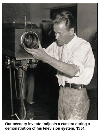 Our mystery inventor adjusts a camera during a demonstration of his television system, 1934.
